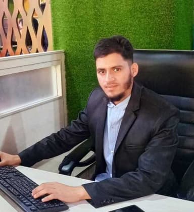 Porosh Hossain working at his desk